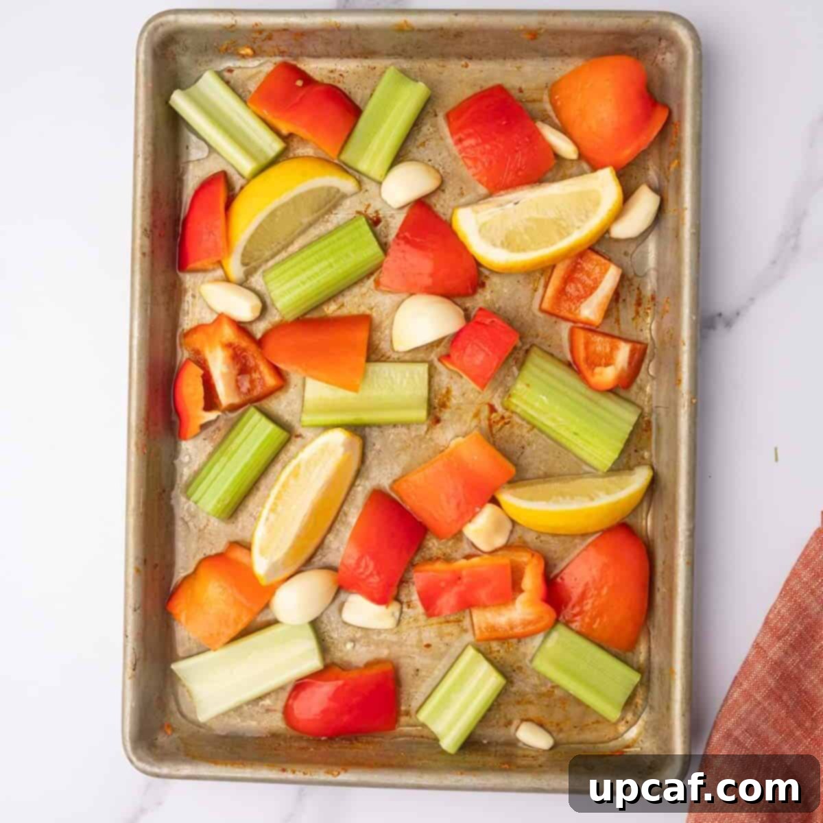 Vegetables are arranged on a tray with fresh herbs.