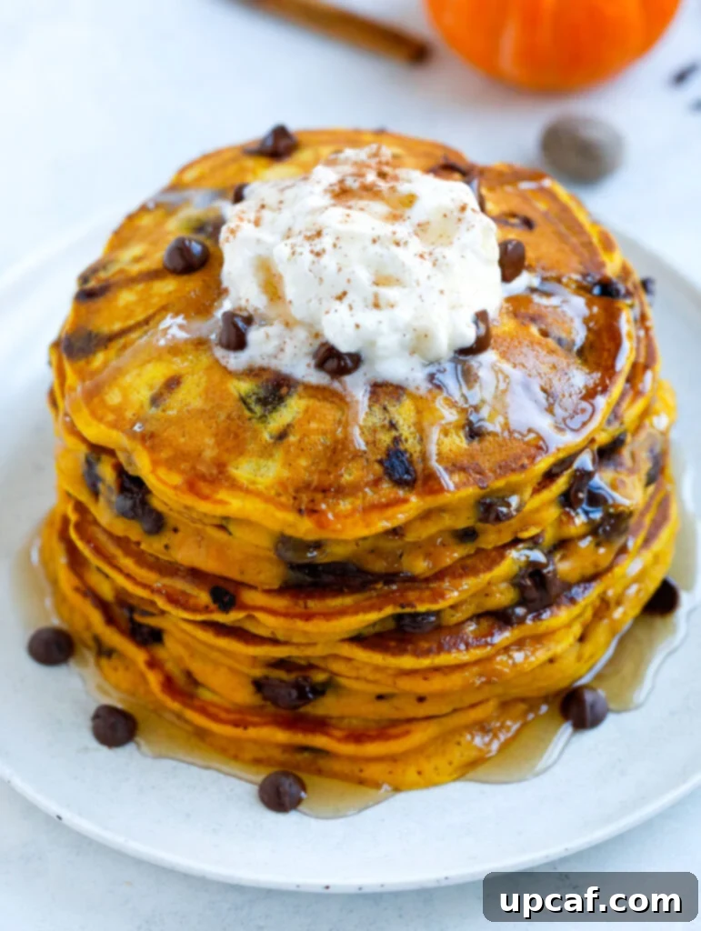 Delicious Pumpkin Chocolate Chip Pancakes stack of Pumpkin Spice Pancakes with chocolate chips and syrup