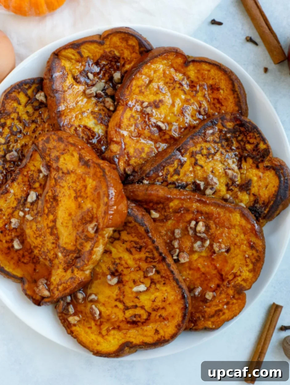 Delicious pumpkin French toast topped with maple syrup and crushed pecans, ready to be enjoyed as a perfect fall breakfast.