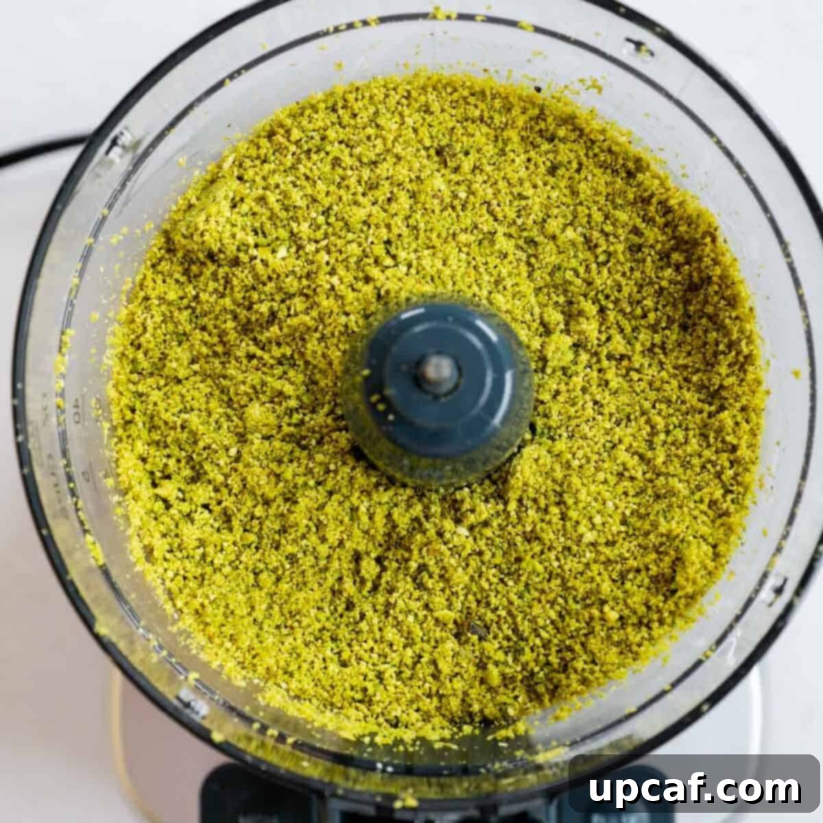 Velvety Pistachio Cream 5 Semi-ground pistachios starting to form a paste in a food processor.