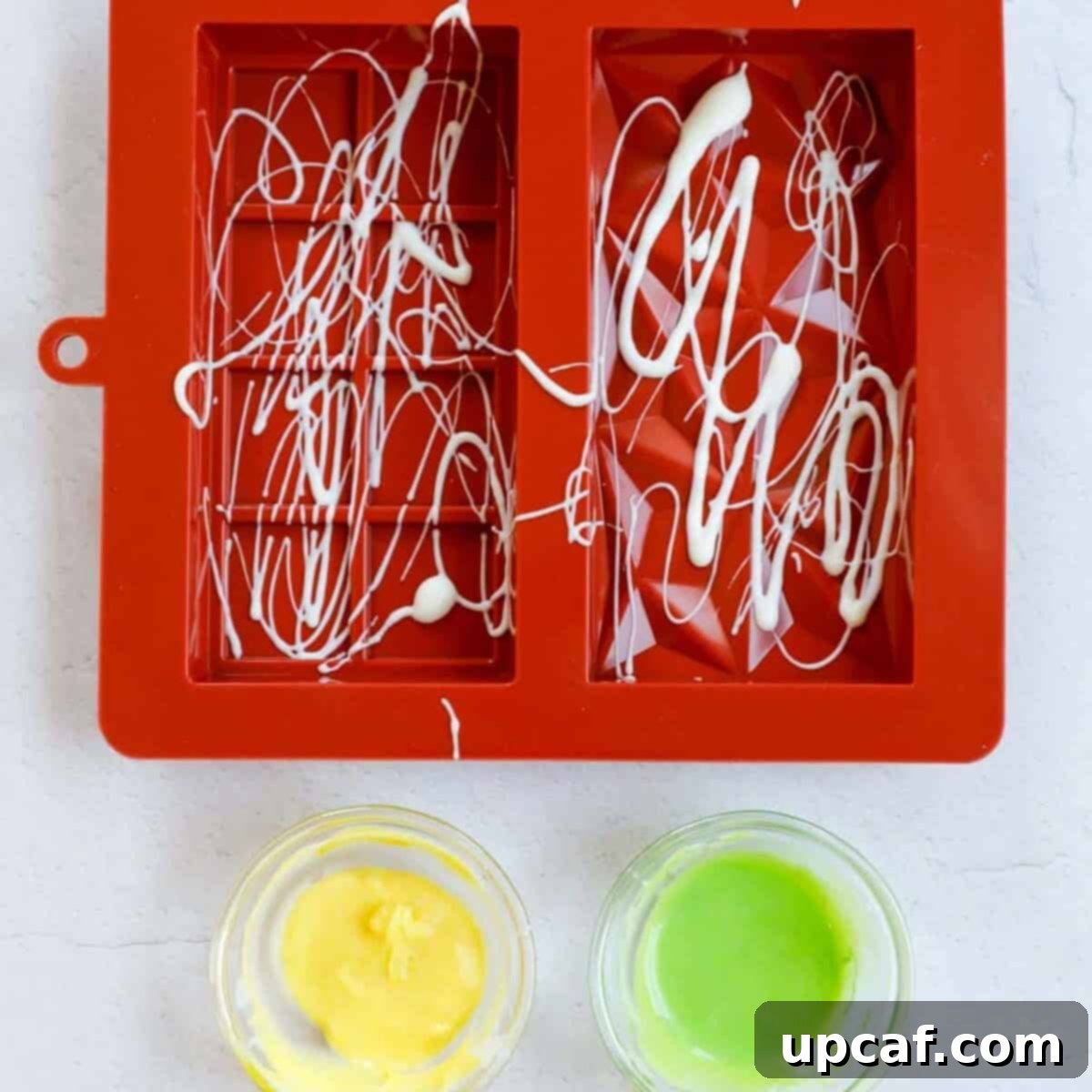 Adding chocolate to the chocolate mold.