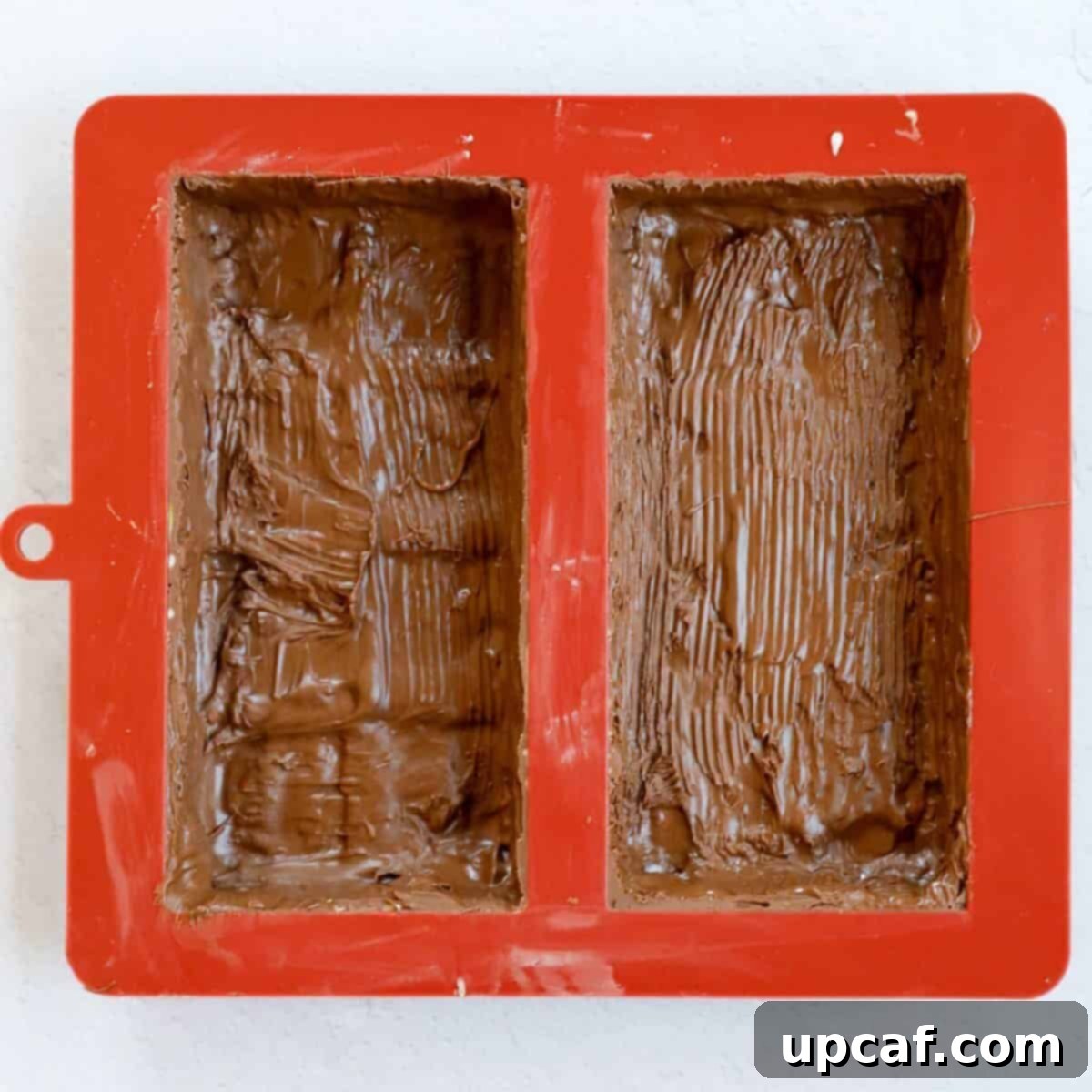 Process of coating the chocolate mold with chocolate to make the outer shell.