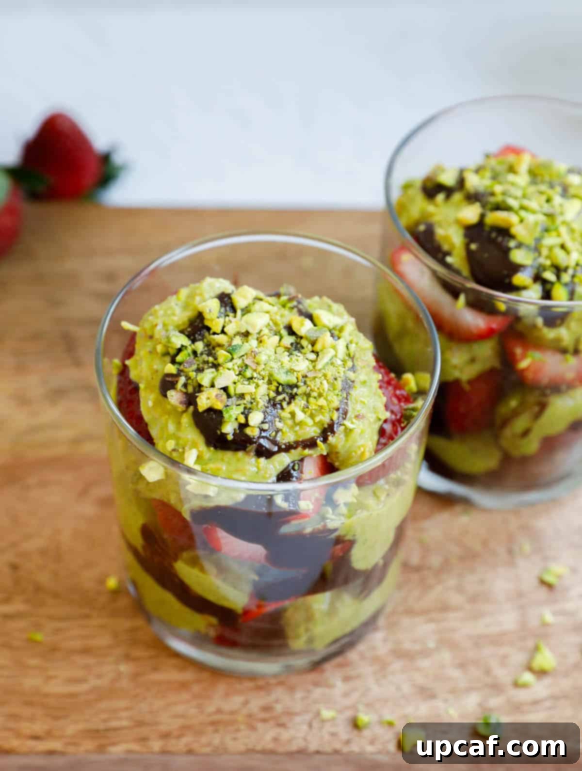Top down shot of Dubai Strawberry Cup, showcasing layers of crispy kataifi, pistachio, chocolate, and fresh strawberries.