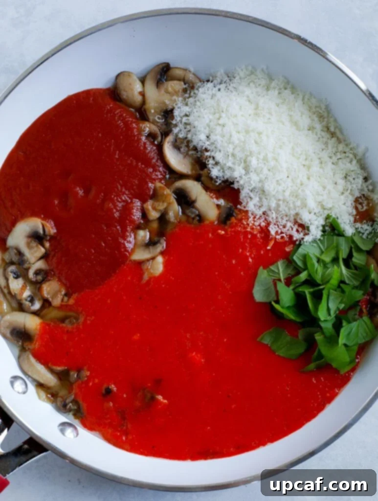 Close-up of the smooth, rich red pepper pasta sauce in a pan, ready for the next steps
