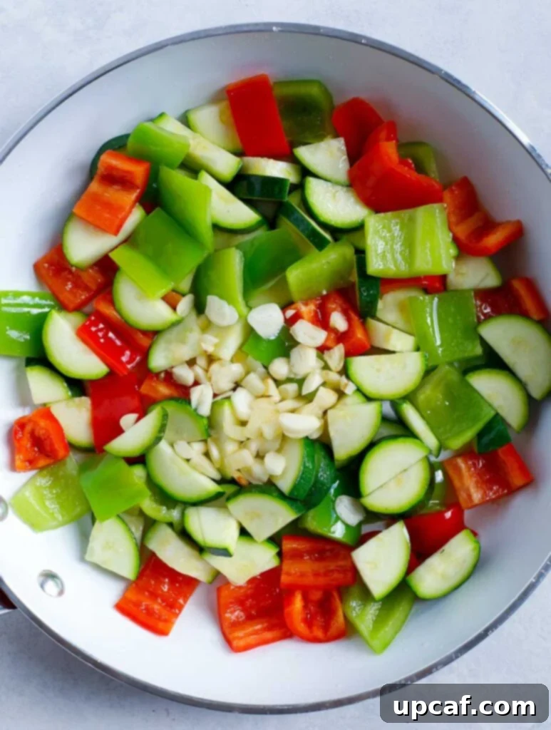 Sautéing Vegetables for Stir Fry Freshly chopped red and green bell peppers and zucchini sautéing in a hot skillet, ready for stir-frying.