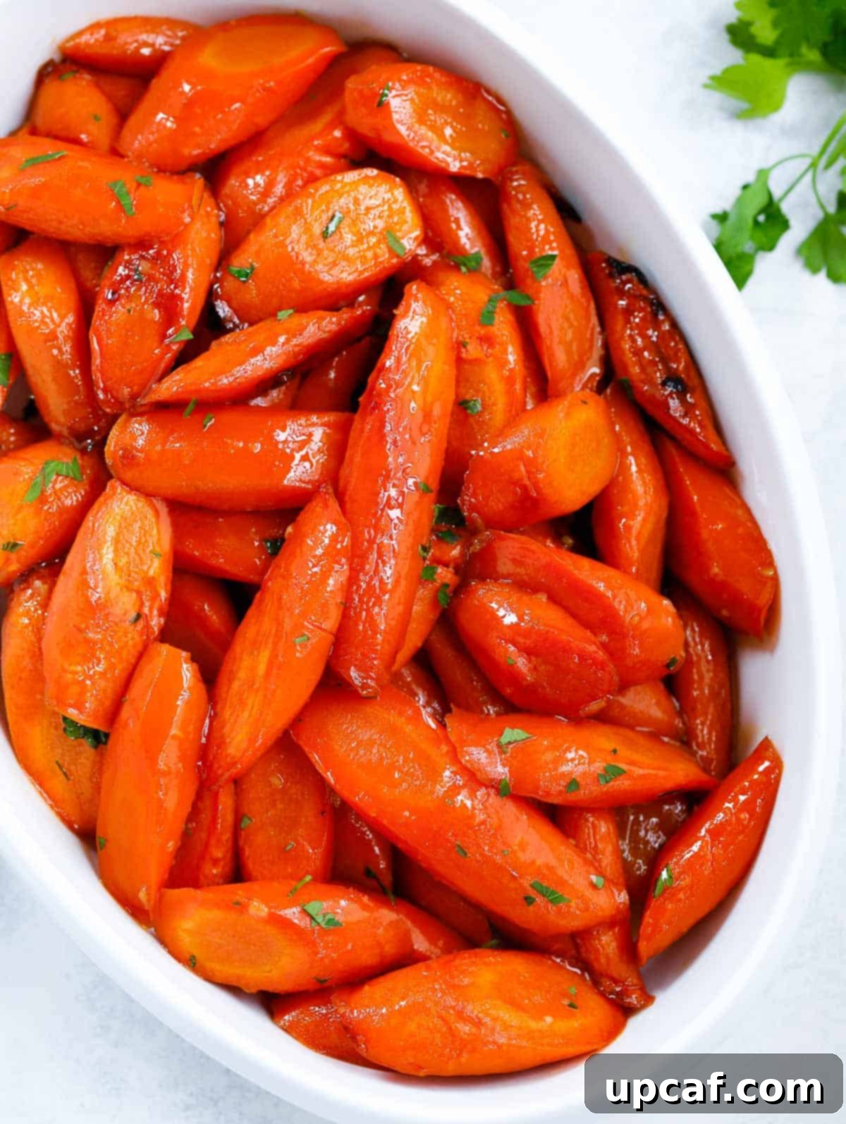 brown sugar glazed carrots in a white serving dish