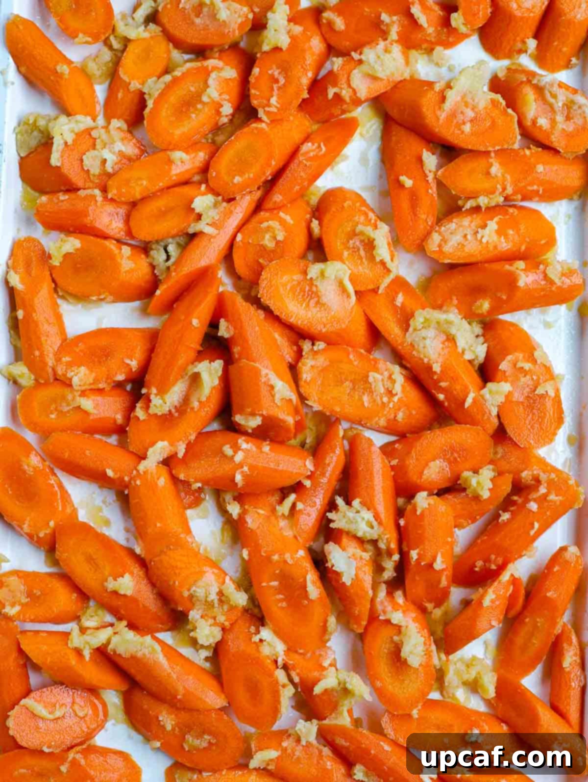 uncooked brown sugar glazed carrots on sheet pan