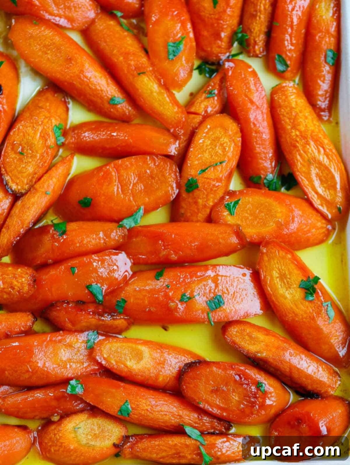 close up shot of the brown sugar glazed carrots on a sheet pan