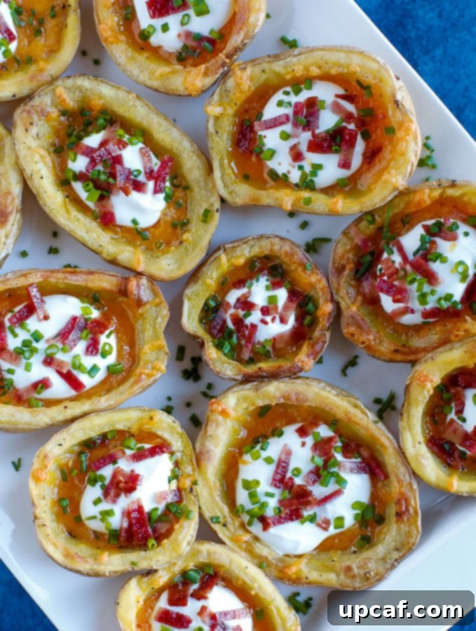 potato skins Crispy Baked Potato Skins artfully arranged on a serving tray, adorned with their delicious toppings and ready to be enjoyed by guests.