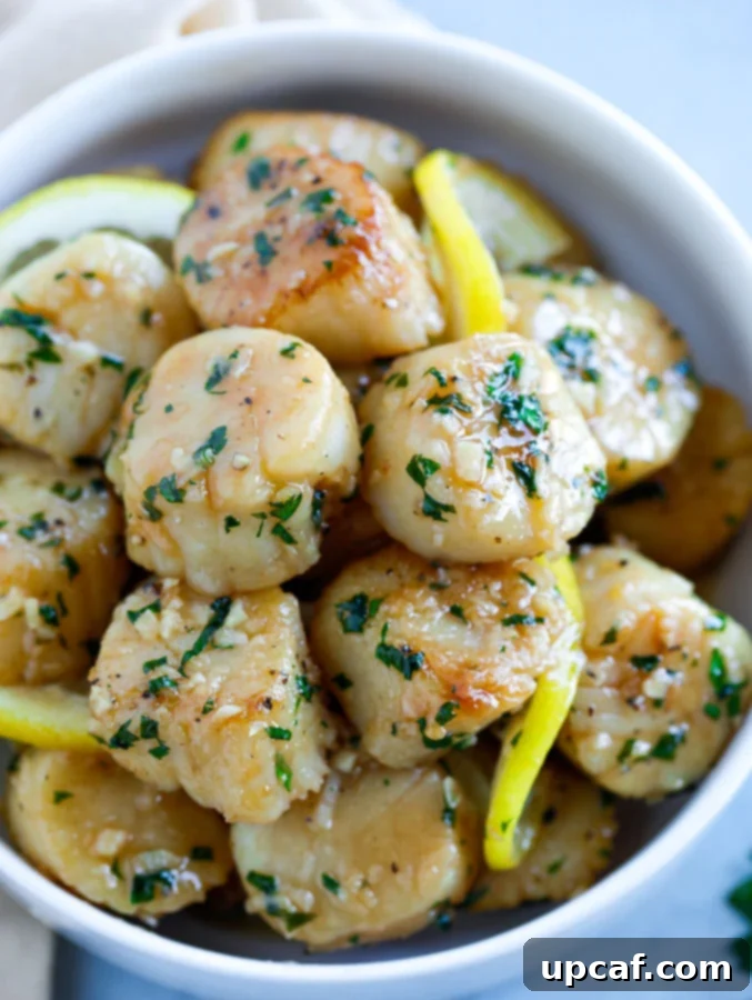 garlic butter scallops A generous batch of golden-brown garlic butter scallops artfully arranged in a rustic bowl, ready for serving.
