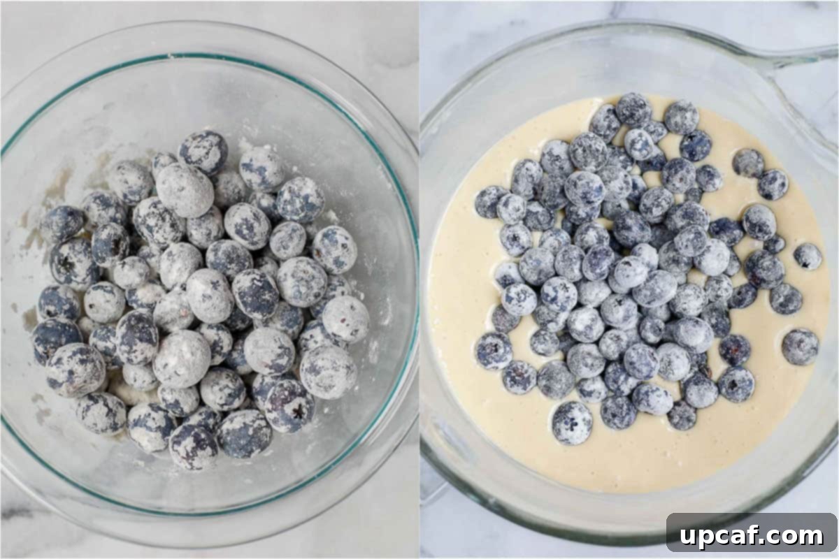 The process of dusting fresh blueberries with flour and gently folding them into the cake batter.