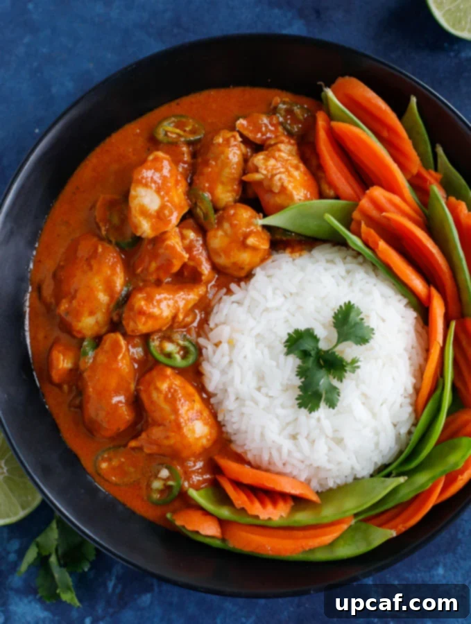Delicious Thai Red Curry Chicken A vibrant bowl of Thai Red Curry Chicken, garnished with fresh herbs, ready to be served
