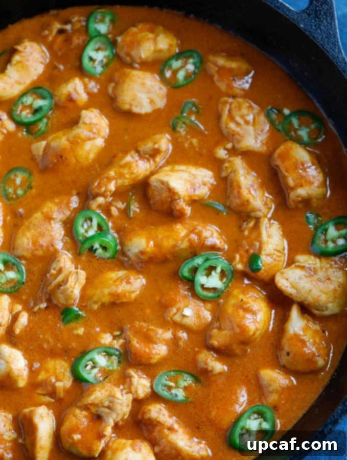 THAI RED CURRY CHICKEN: A CLASSIC RECIPE WITH COCONUT MILK AND VEGETABLES 4 Top-down view of Thai Red Curry Chicken, garnished with fresh cilantro in a serving bowl