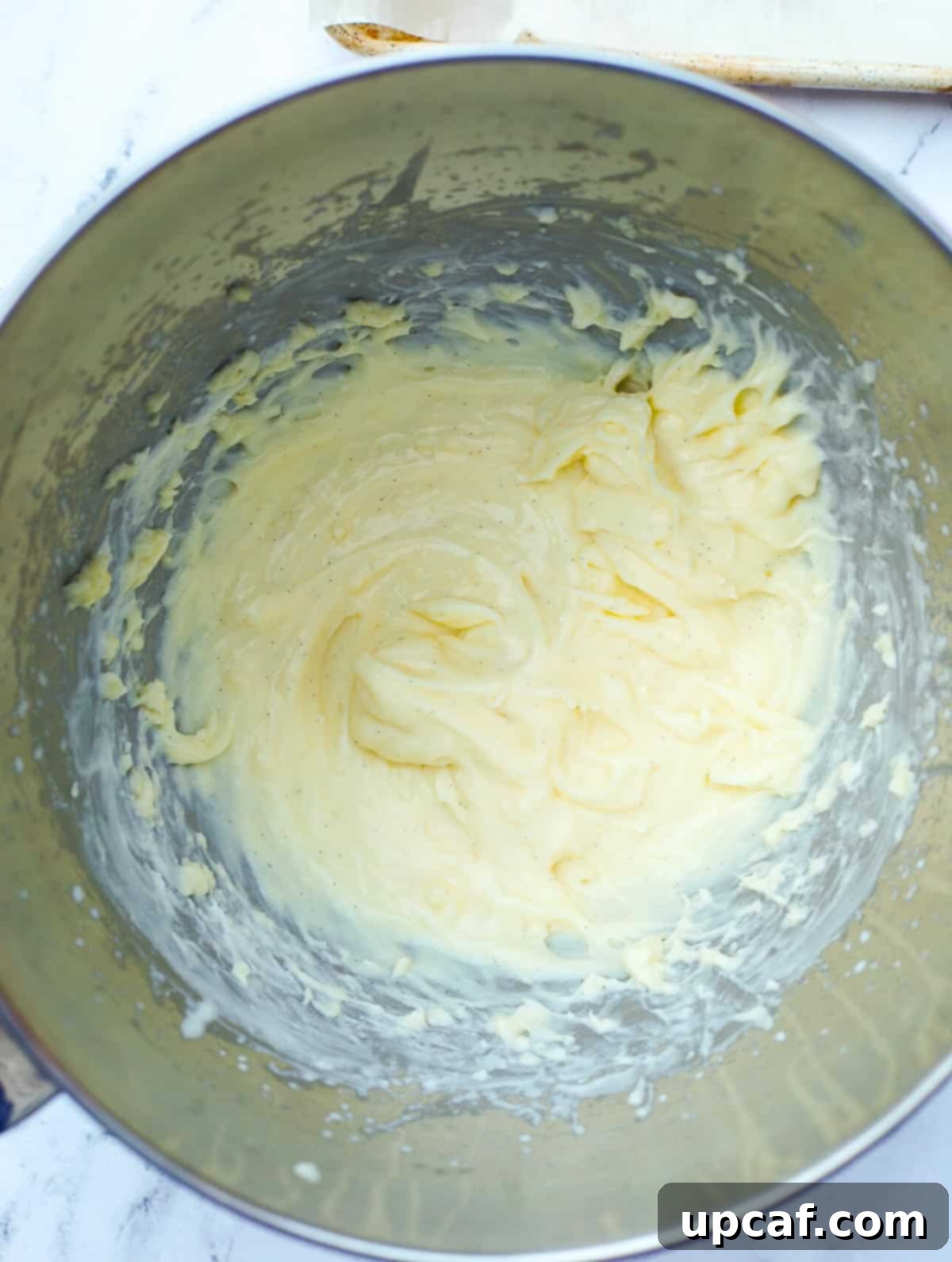 A close-up view of light and fluffy pastry cream filling, expertly whipped with heavy cream, showcasing its creamy texture.