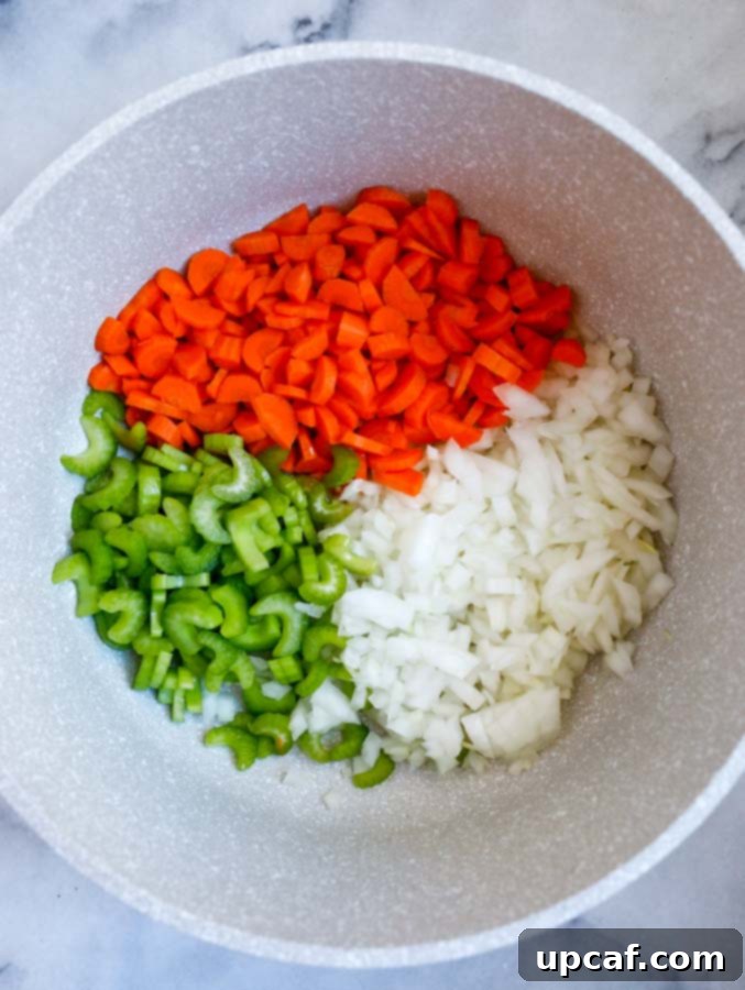 Bright Lemon Chicken Orzo Soup 2 Lemon Chicken Orzo Soup ingredients laid out on a cutting board.