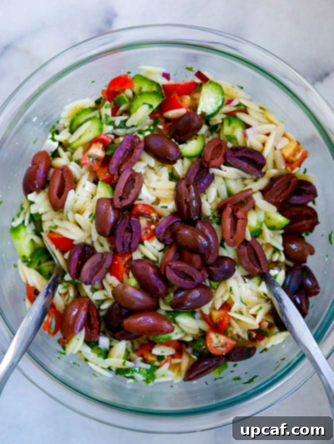 Pouring homemade Greek dressing over fresh salad ingredients