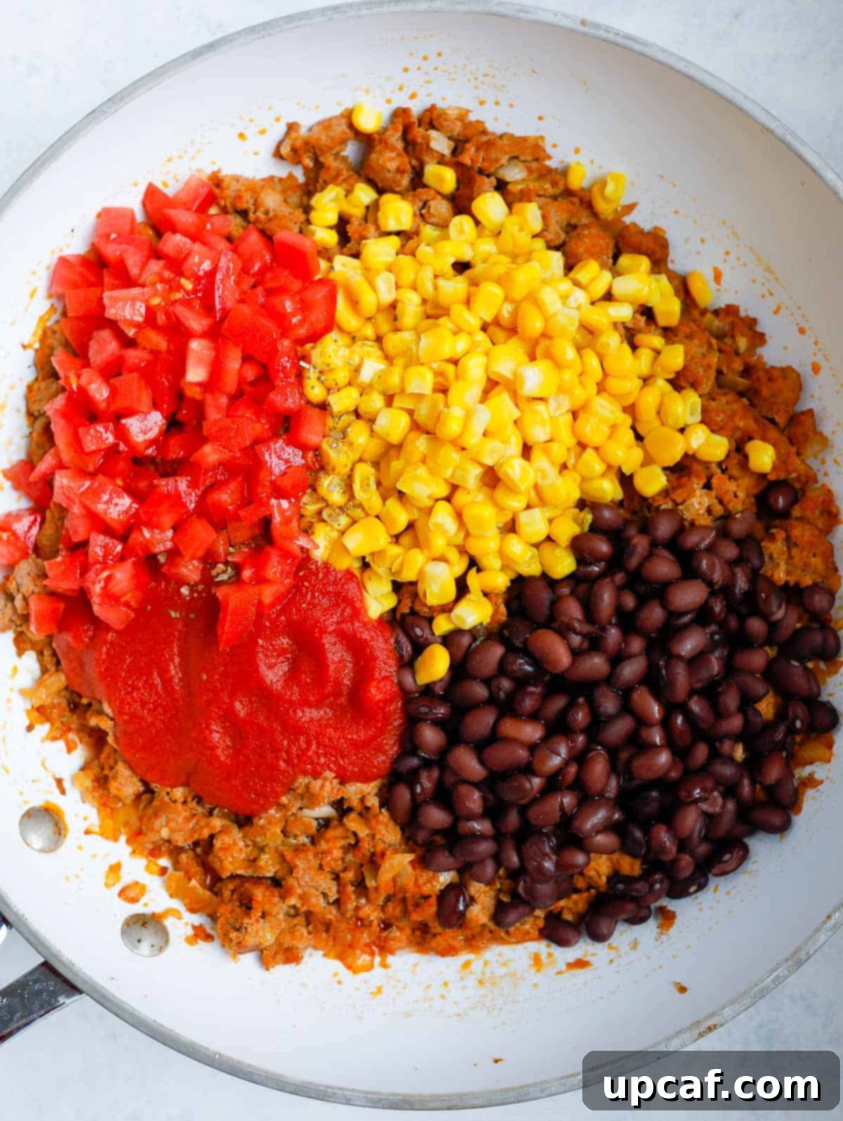 Loaded Zucchini Boats 4 Rich and savory stuffing mixture cooking in a large frying pan.