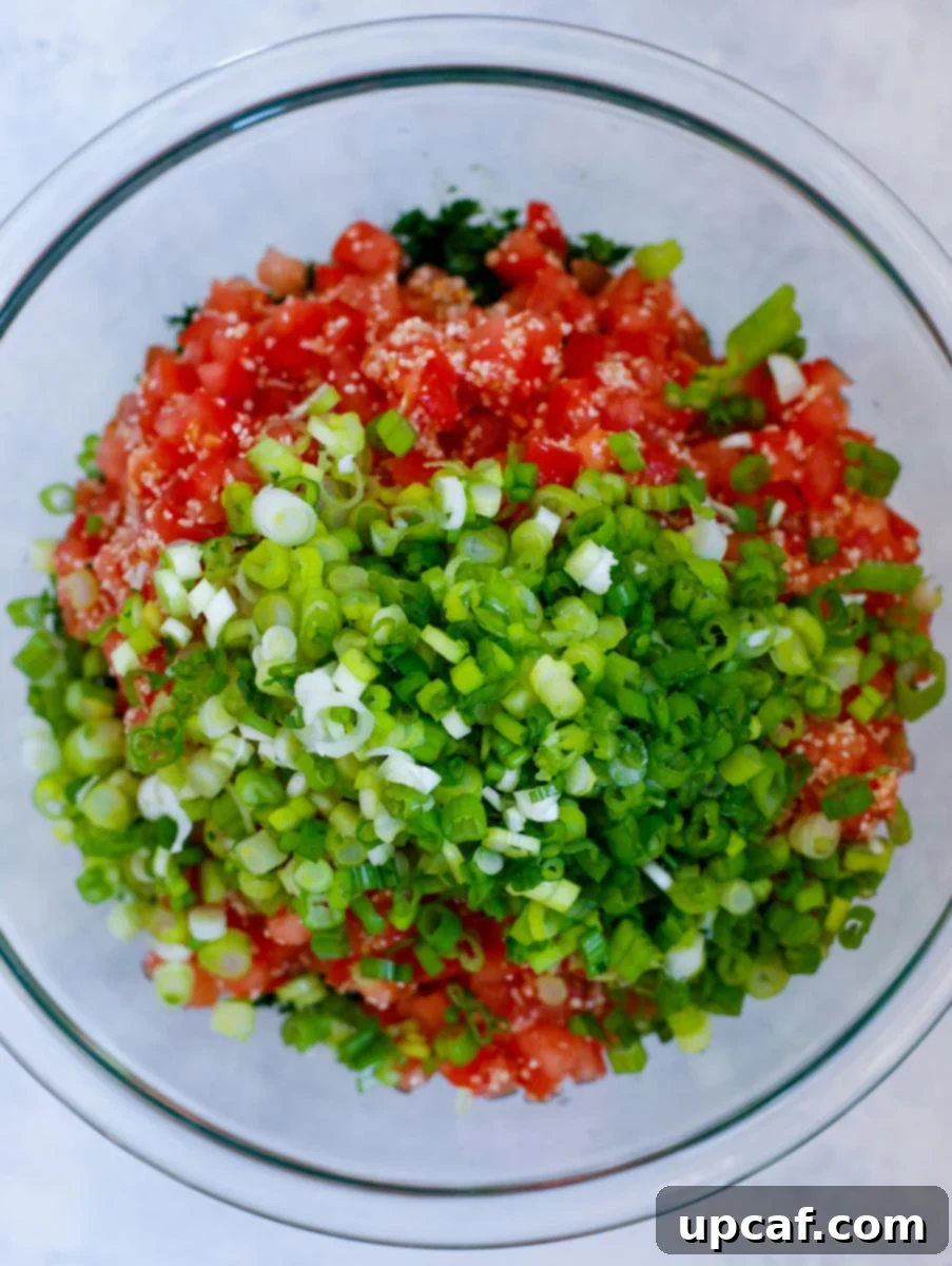 The tabbouleh salad ingredients in a glass bowl