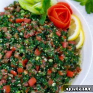 Lebanese tabbouleh garnished with sliced lemons and vegetables