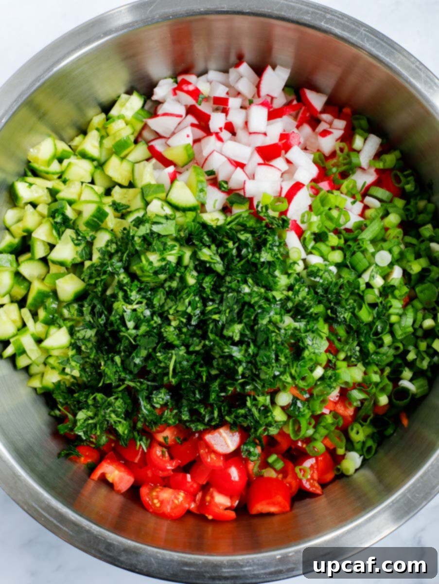 Crisp Cabbage Fattoush 6 The chopped and mixed vegetables for Cabbage Fattoush Salad presented in a spacious glass mixing bowl.