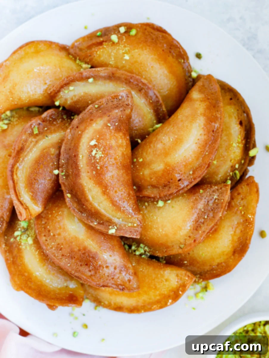 finished Atayef placed on a plate and garnished with pistachios