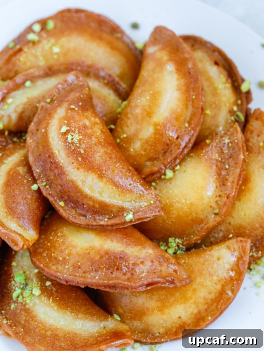 fried atayef garnished with ground pistachios