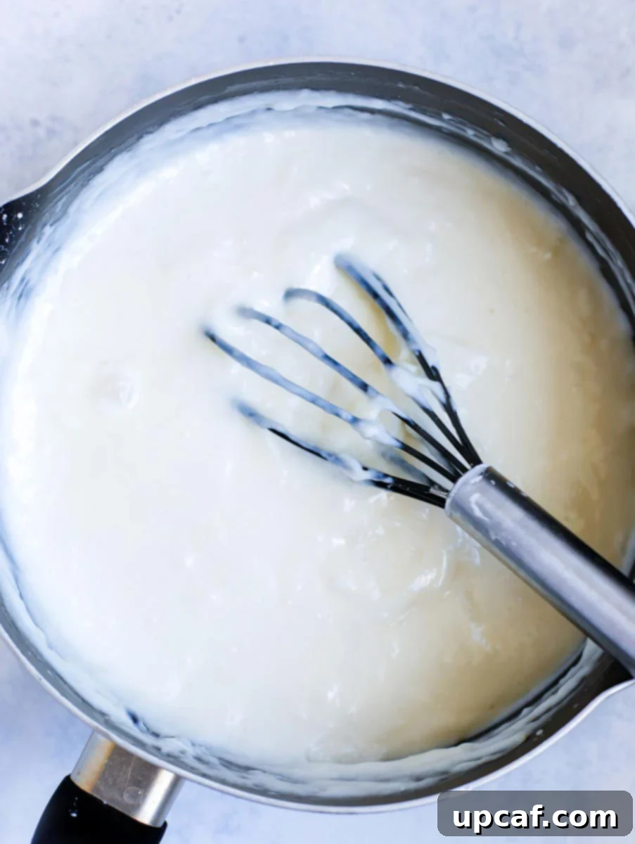 ashta filling in a pot with a whisk