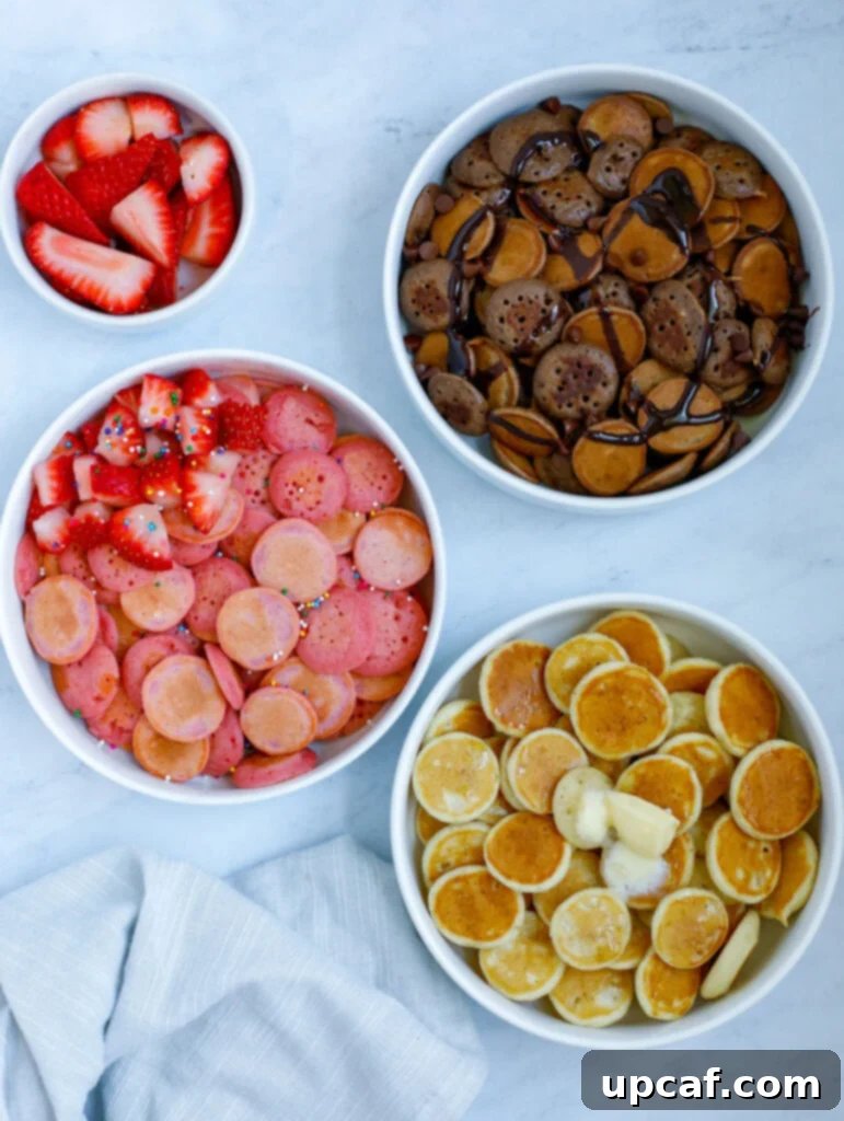 A vibrant collage featuring three distinct flavors of mini pancake cereal: classic golden, rich chocolate, and playful pink strawberry, artfully arranged to showcase their variety.