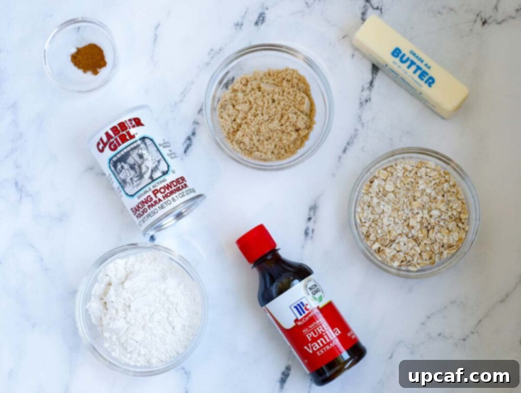 Ingredients for the crisp topping including rolled oats, flour, butter, brown sugar, baking powder, and cinnamon, arranged on a surface.