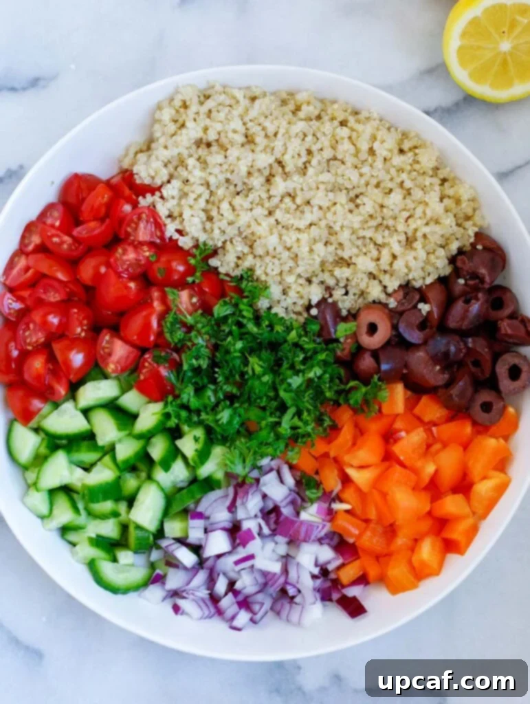 Vibrantly chopped ingredients for Mediterranean quinoa salad, including tomatoes, cucumbers, bell peppers, olives, and fresh parsley, arranged neatly on a wooden board.