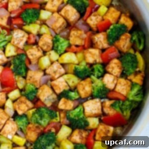 Close up of salmon and veggies in a skillet