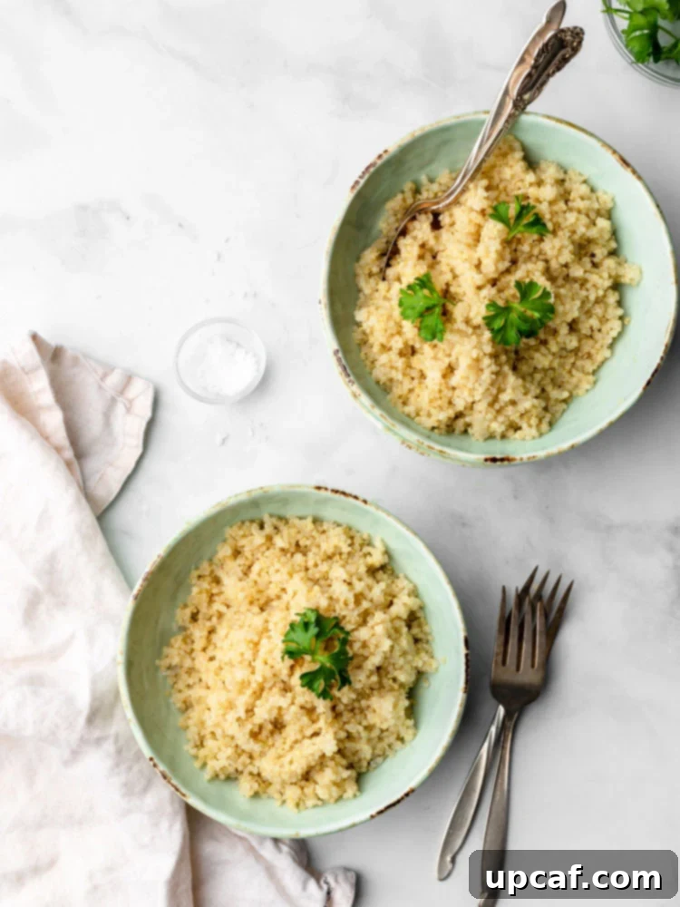 Two bowls of perfectly cooked quinoa, garnished with fresh parsley, ready for a healthy meal.