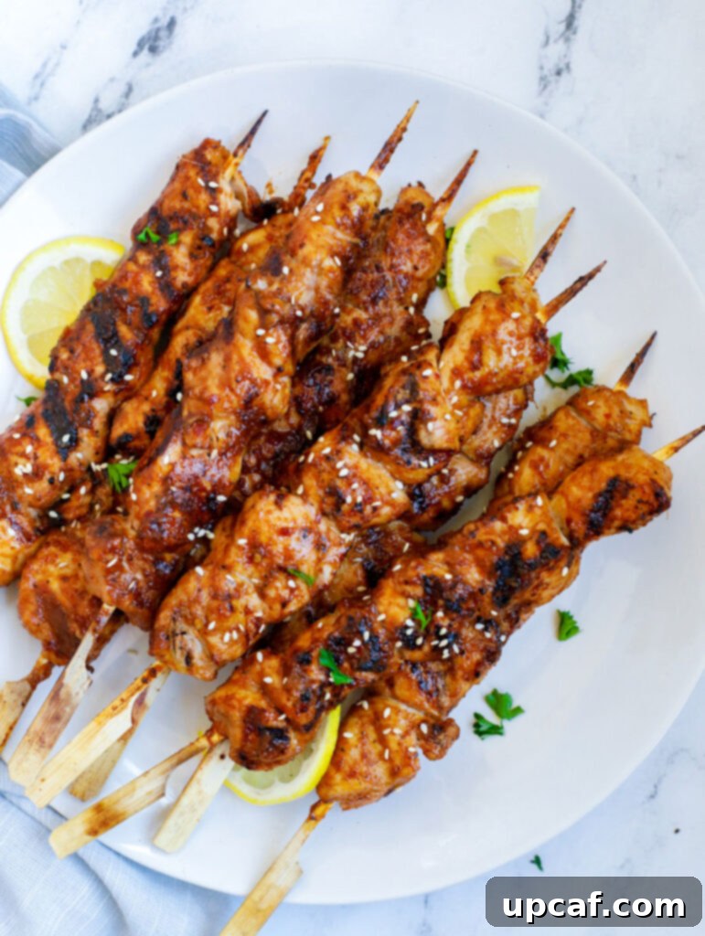 Seoul Street Chicken Skewers 2 Platter of Korean BBQ Chicken Skewers garnished with sesame seeds and parsley