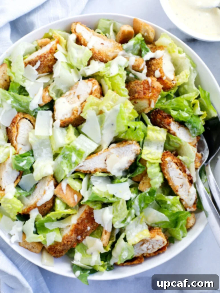 Crispy Chicken Caesar Salad served in a bowl, featuring golden-brown chicken tenders, fresh romaine lettuce, and parmesan cheese