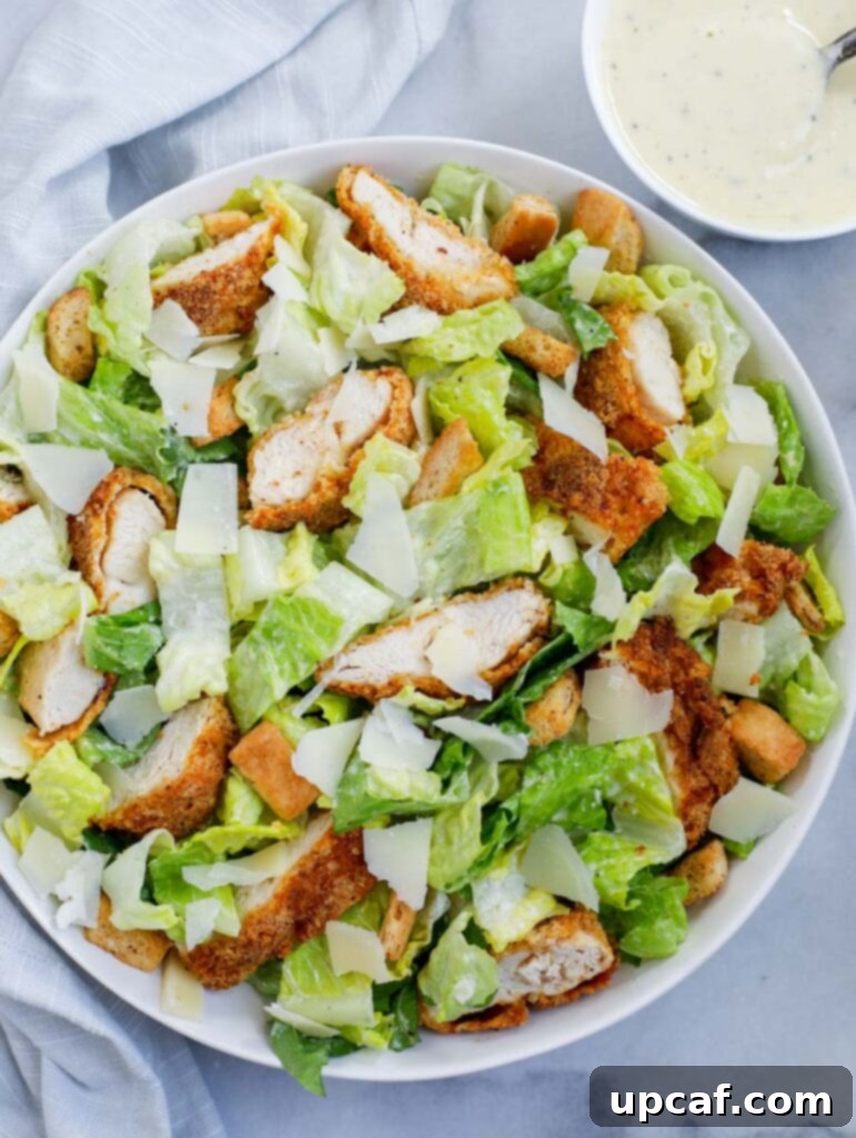Top-down shot of a beautifully arranged Crispy Chicken Caesar Salad in a dish