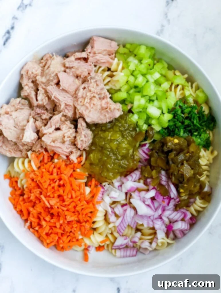 The Ultimate Tuna Pasta Salad 4 Tuna Pasta Salad ingredients in a white bowl