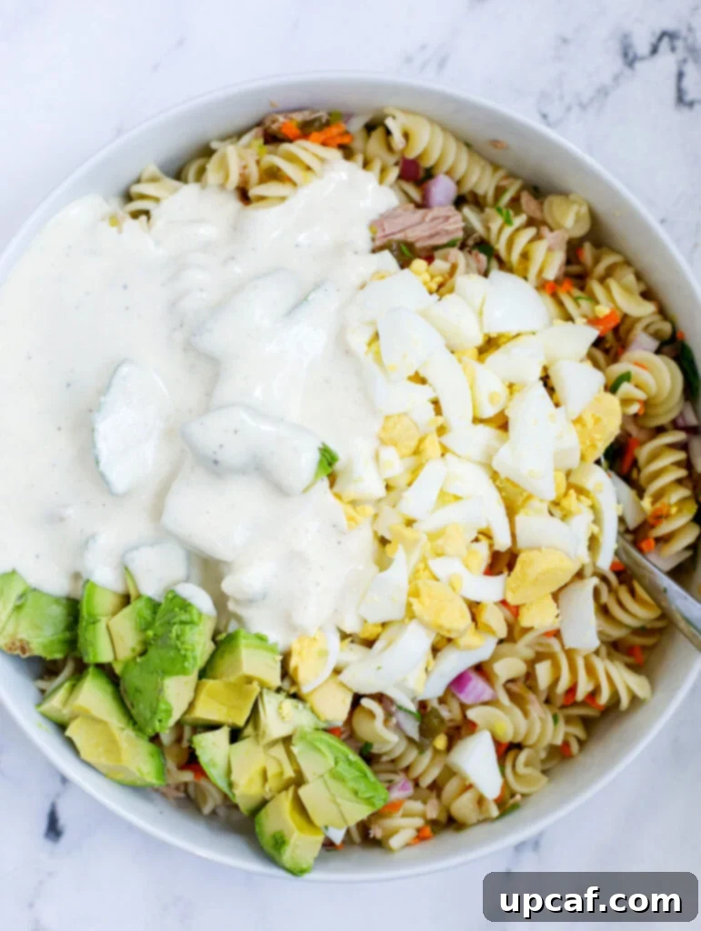 The Ultimate Tuna Pasta Salad 6 dressing on top of pasta salad
