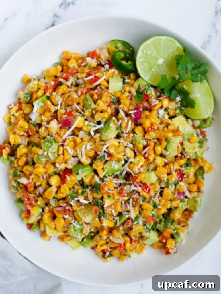 Top down view of Mexican street corn salad in a rustic bowl, garnished with fresh cilantro and cotija cheese.