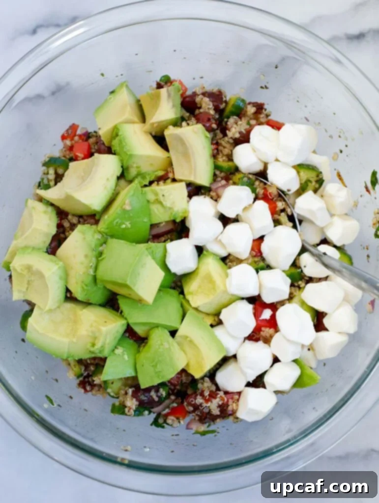 diced avocado and mozzarella balls in a bowl