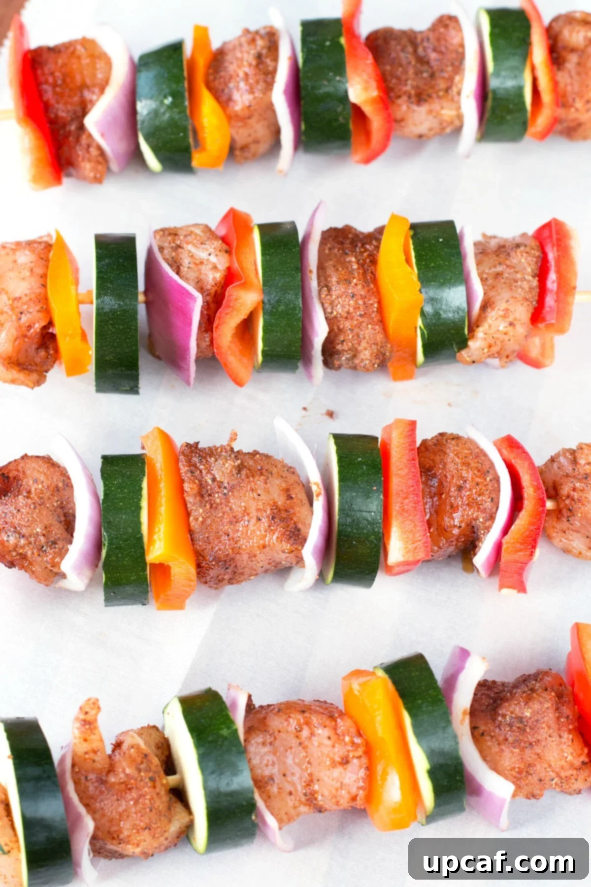 Fiery Chili Chicken Skewers with Rainbow Peppers 5 Chicken skewers with vegetables seasoned and waiting to be cooked