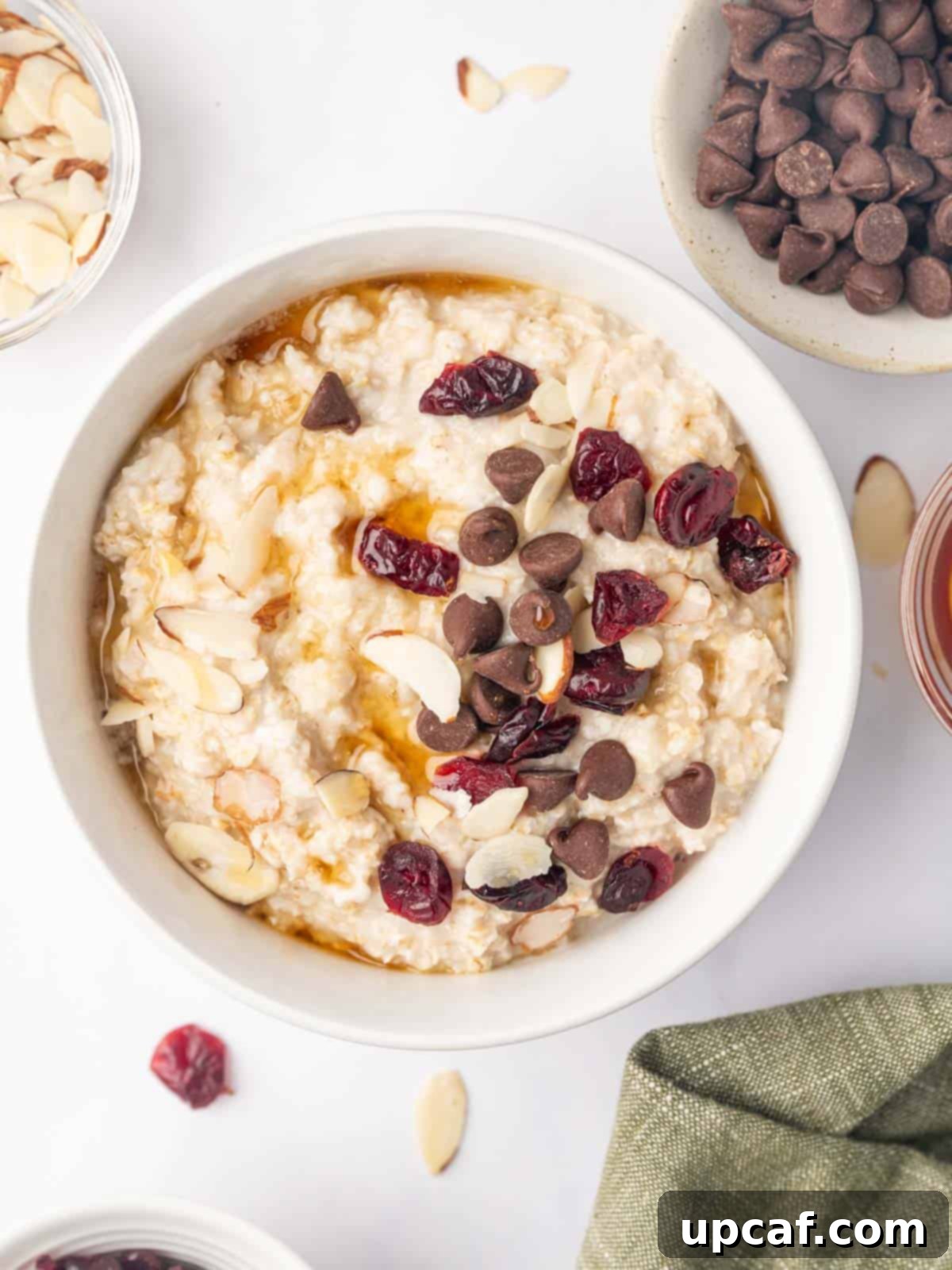 Microwaved rolled oats in a bowl topped with chocolate chips and nuts.