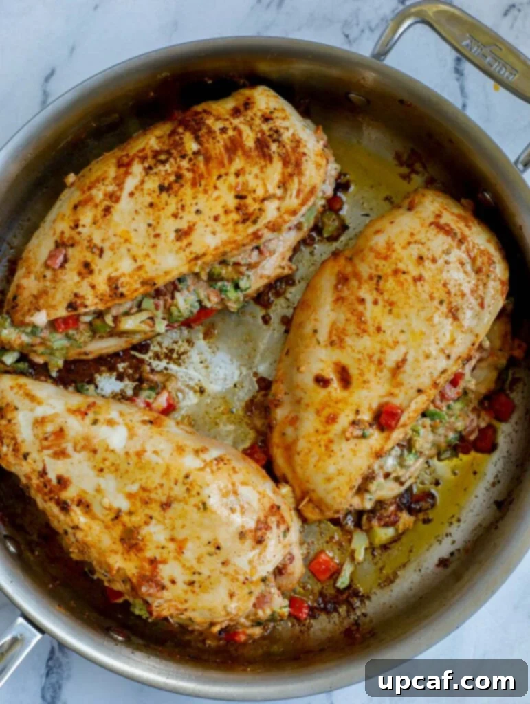 Broccoli and Cheese Stuffed Chicken cooking in a cast iron skillet