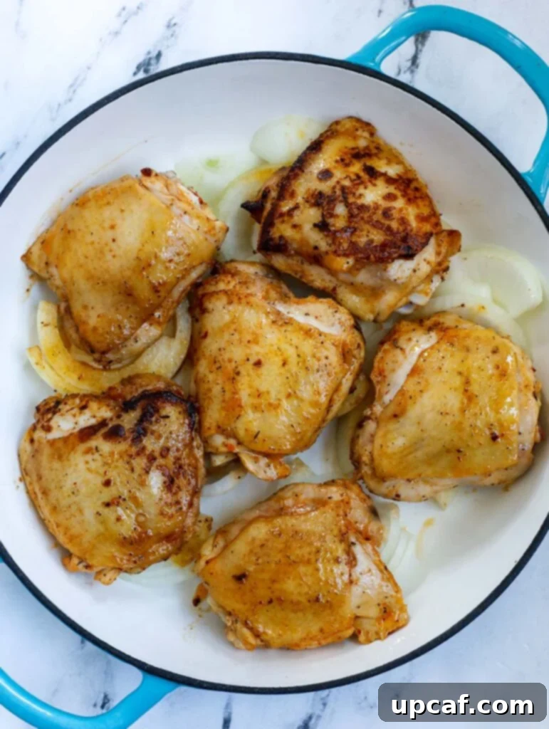 Rustic Chicken and Potato Bake 4 Overhead shot of chicken thighs marinating in a bowl