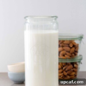 Fresh Almond Milk From Scratch 11 homemade almond milk in a jar with whole almonds in the background