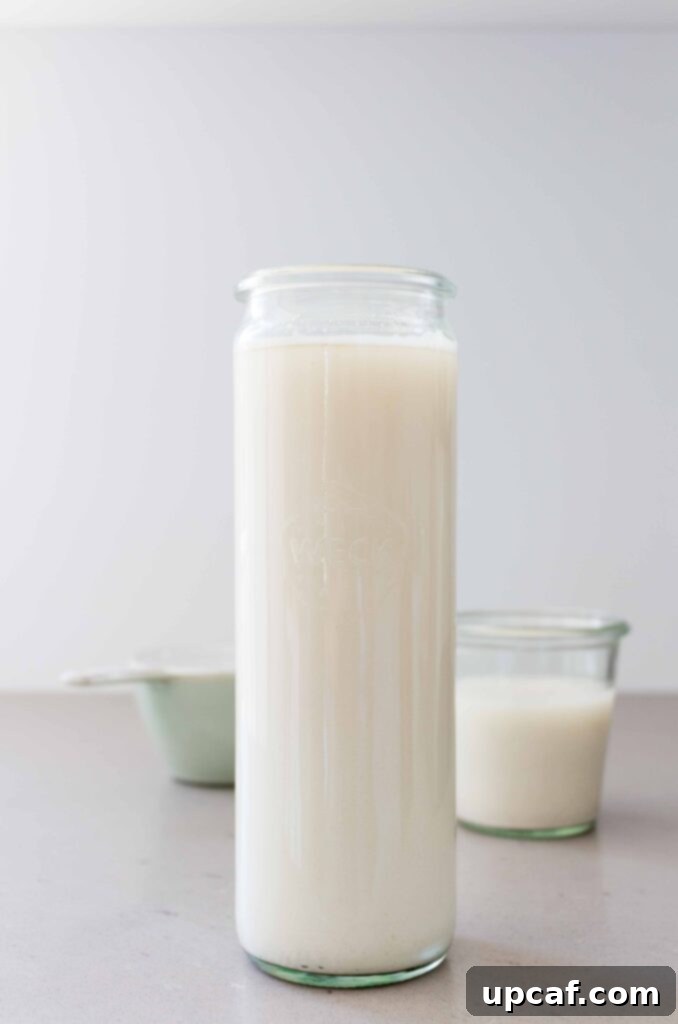 A bottle of freshly made homemade oat milk, ready for storage and consumption.