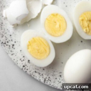 A hard-boiled egg sliced in the middle showing the yolk.