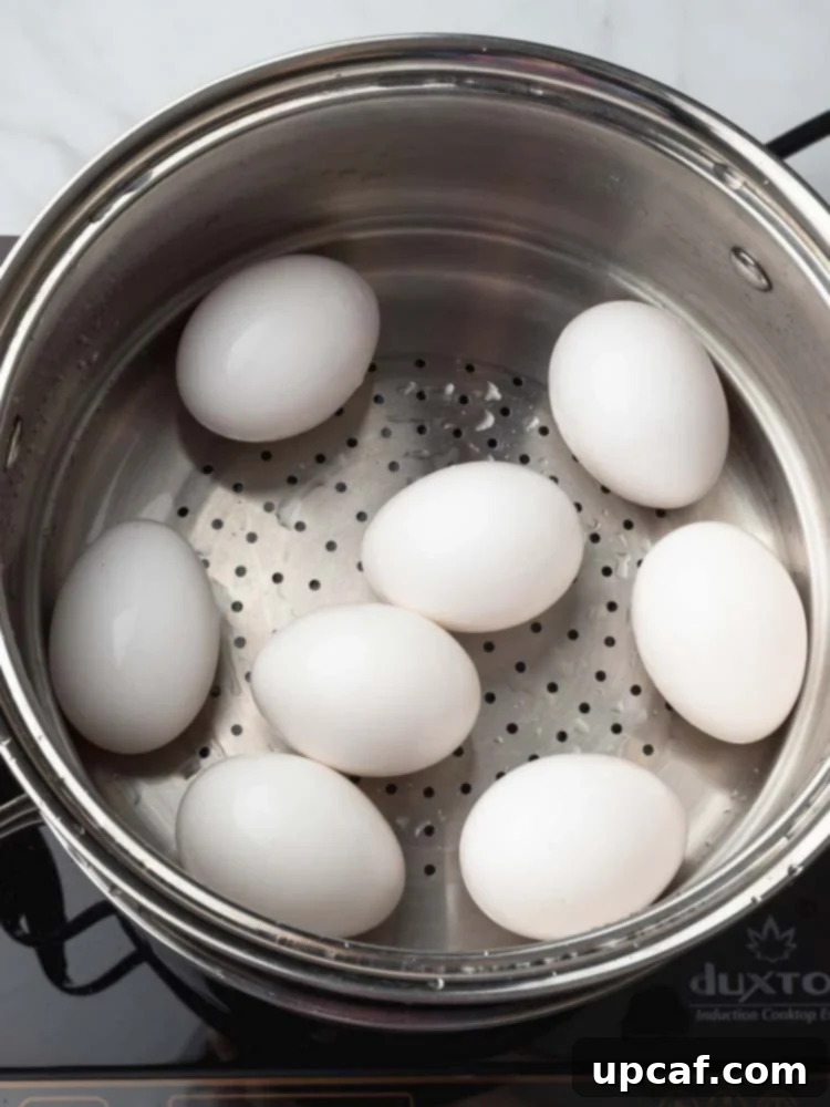 Eggs cooking on a trivet inside an Instant Pot, steam visible.