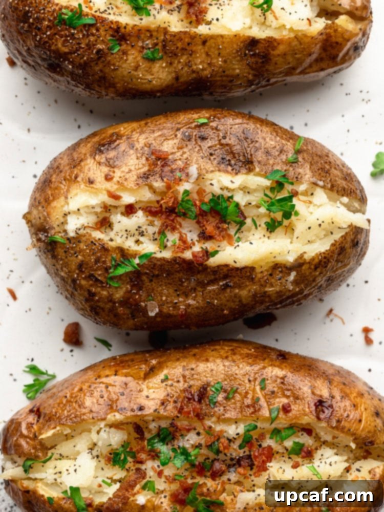 top down close up shot of baked potatoes topped with bacon and parsley