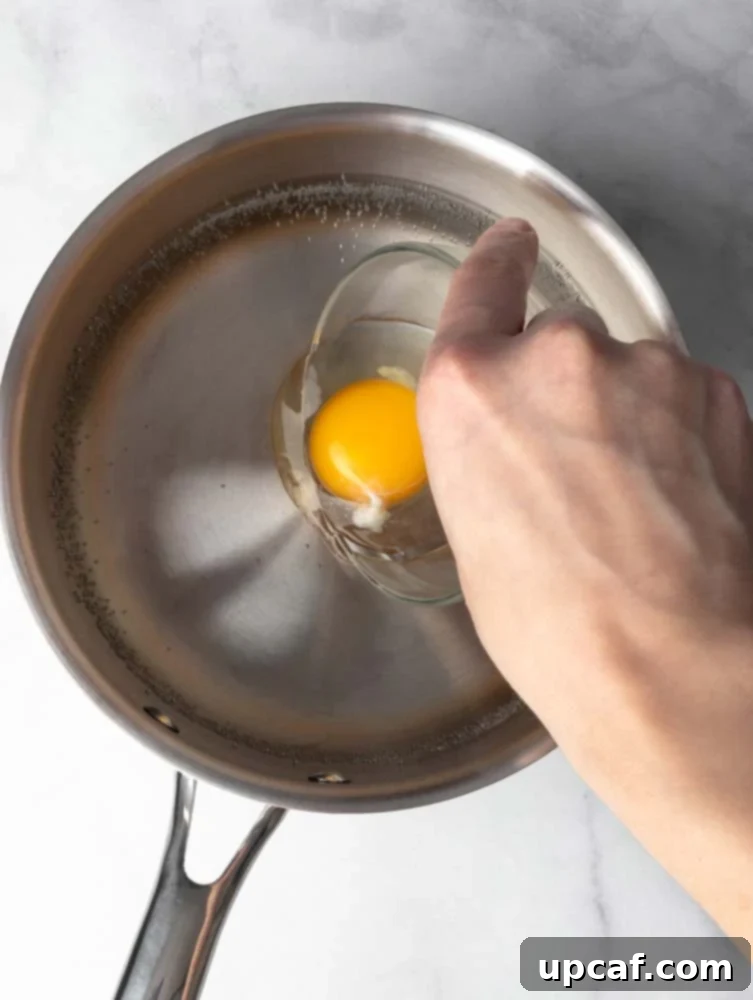 Egg being dropped into a pot with hot water creating a whirlpool