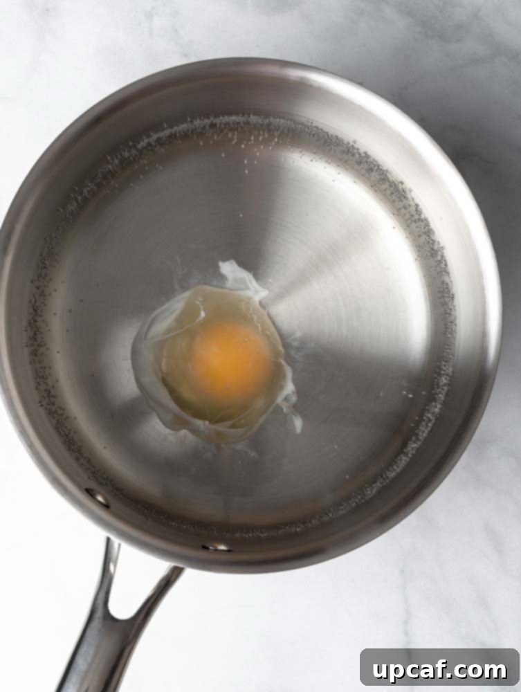 Egg poaching in simmering water